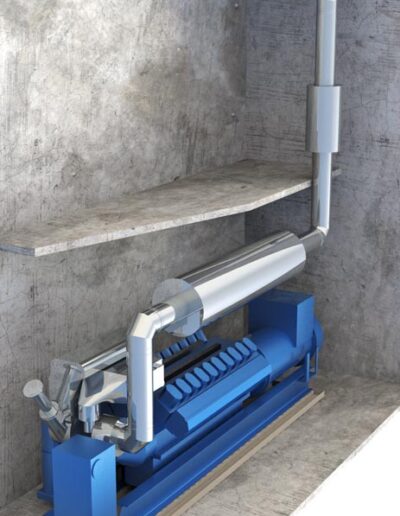 Blue industrial pump with white PVC piping mounted in a concrete wall alcove.