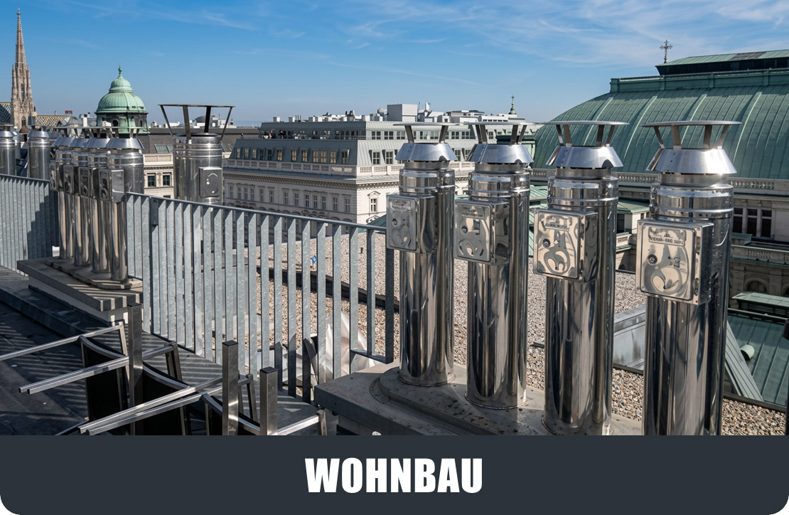 moldrich-26-start-05b Rooftop railing with shiny metal posts overlooks a historic cityscape featuring green-domed copper roofs and ornate buildings under a blue sky.